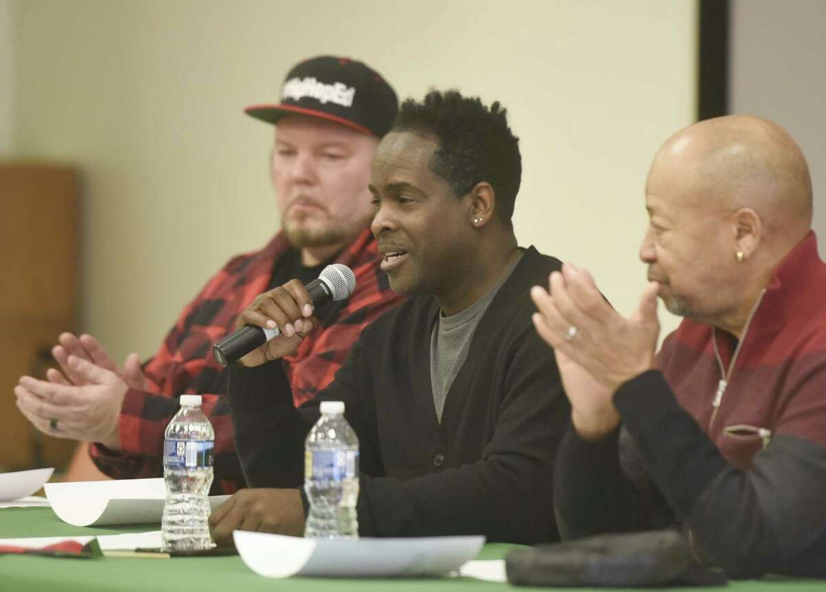 Song writer and vocalist Robbie Jenkins, center, speaks beside performer and song writer David Wooley, left, and vocalist Richard Thomas during the panel discussion at the Black History Month Open Mic Competition at Ferguson Memorial Library in Stamford, Conn. Sunday, Feb. 18, 2018. Panelists discussed hip hop music and the entertainment industry before judging the Black History-themed open mic contest, including spoken word, song, and instrumental performances.