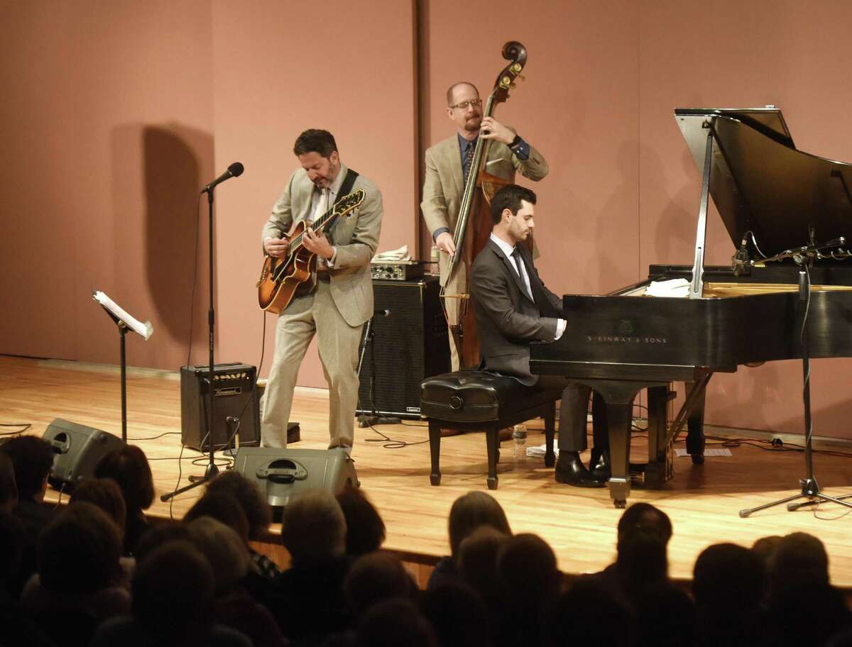 Jazz guitarist and singer John Pizzarelli performs with upright bass player Mike Karn and pianist Konrad Paszkudzki at Greenwich Library's Cole Auditorium in Greenwich, Conn. Sunday, Feb. 18, 2018. Pizzarelli is a virtuoso who performs mostly modern interpretations from the Great American Songbook.