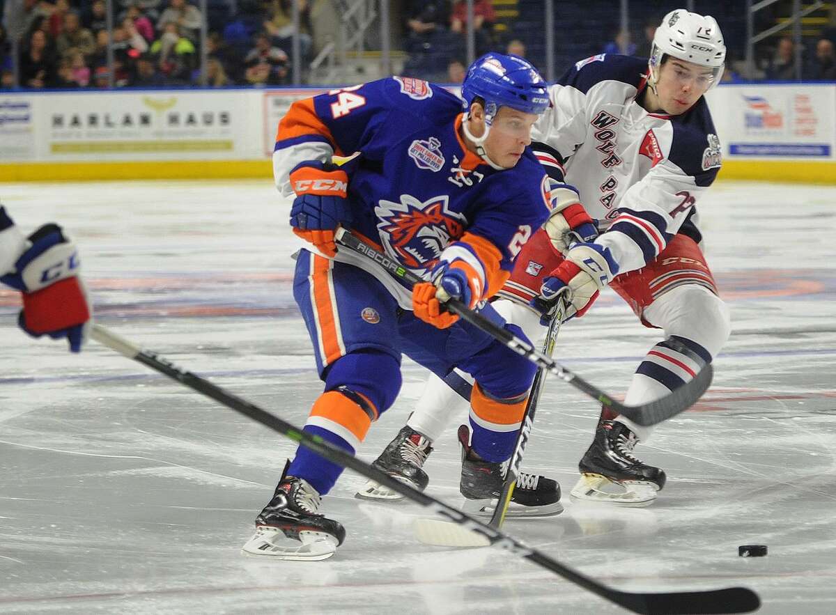 Bridgeport Sound Tiger Travis St. Denis carries the puck in to the offensive zone defended by Hartford's Filip Chytil in the first period of their AHL hockey game at the Webster Bank Arena in Bridgeport, Conn. on Sunday, February 18, 2018.