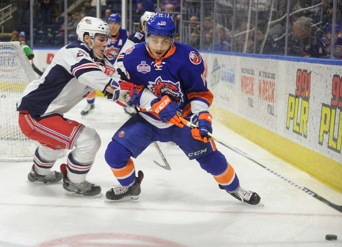 Bridgeport Sound Tiger Ryan Bourque is defended by Hartford's Ryan Graves behind the Wolf Pack net in the first period of their AHL hockey game at the Webster Bank Arena in Bridgeport, Conn. on Sunday, February 18, 2018.
