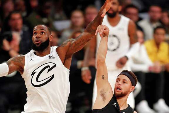 Team Stephen's Stephen Curry and Team LeBron's LeBron James watch Curry's 3-point attempt in 2nd quarter during NBA All Star Game at Staples Center in Los Angeles, Calif., on Sunday, February 18, 2018.
