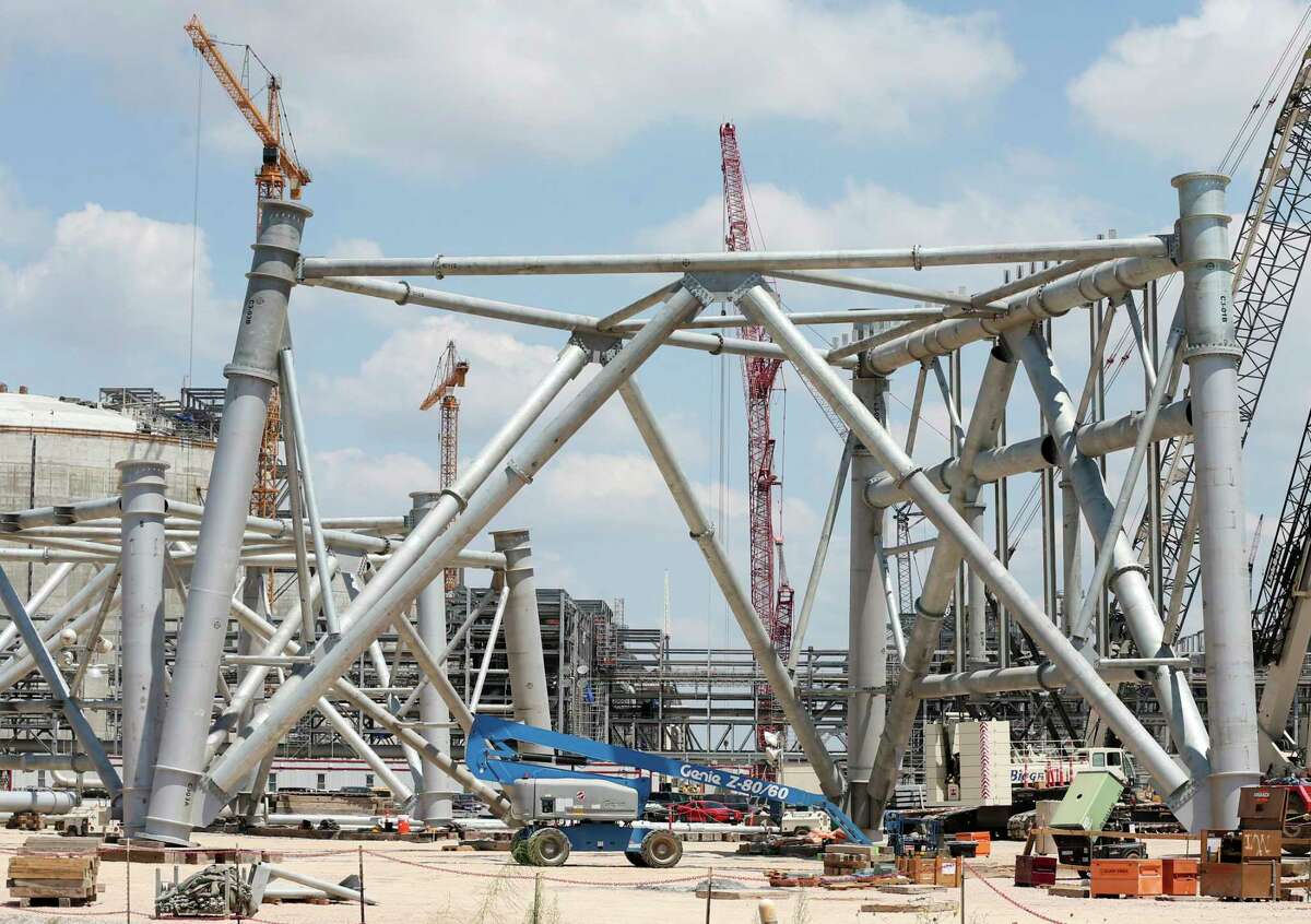 A lift is dwarfed by the base of a 500-foot flaring tower at the Cheniere Liquid Natural Gas plant construction site in Portland, Texas, Wednesday, August 2, 2017. The complete project will have a cost of over $20 billion. The plant will have three trains that will chill the natural gas to -260 degrees Fahrenheit that turns it to a liquid stage in order to transport.