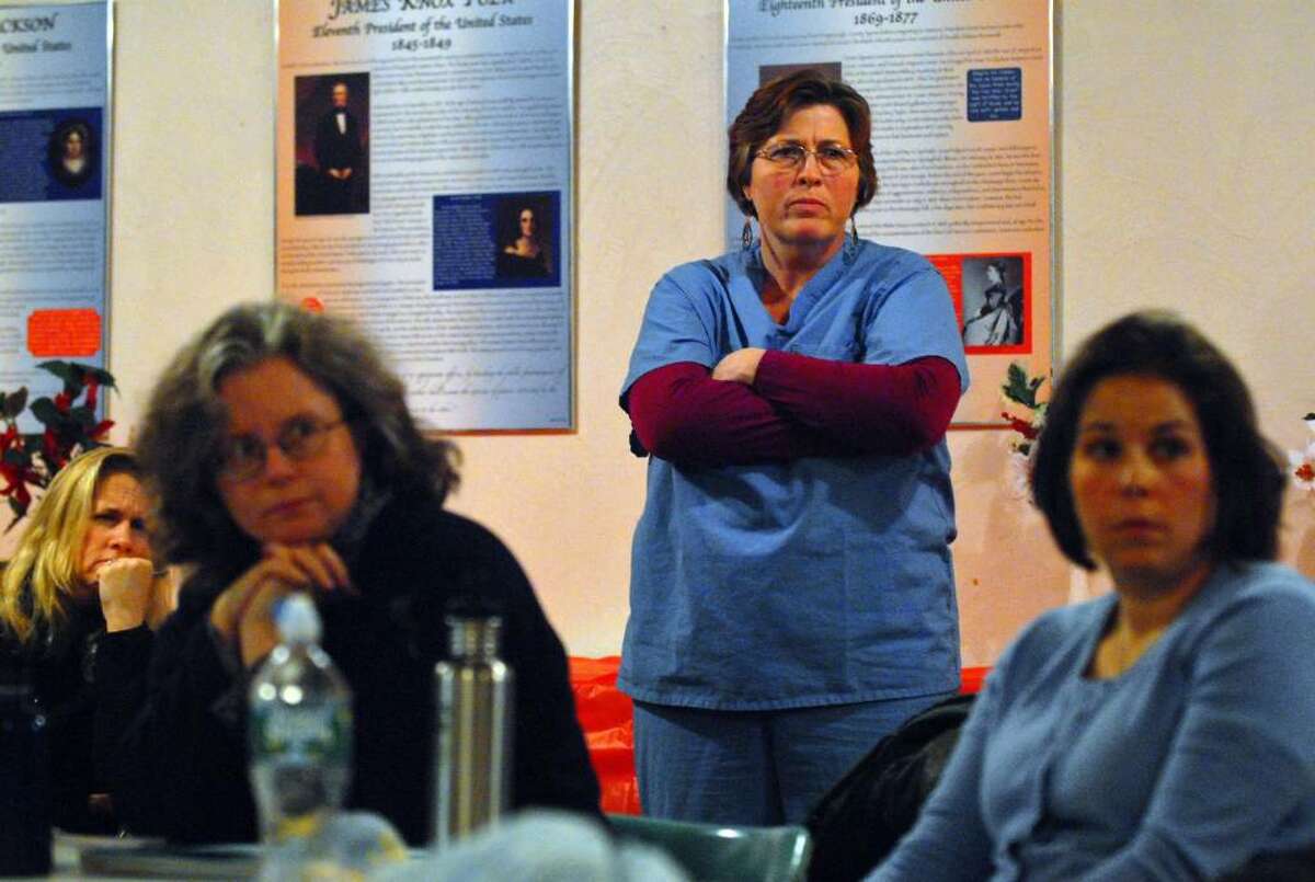 Midwife Kelly McDermott, standing, listens during a meeting of people concerned about the merger of the maternity wards of Samaritan Hospital and Seton Health. (Philip Kamrass / Times Union)