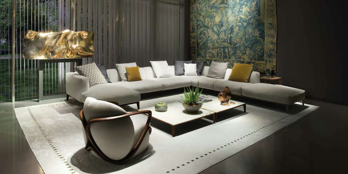 Giorgetti's Hug chair and Aton modular sofa and coffee table are shown in a living room. Giorgetti products are now available at CASA, a new Italian modern luxury story at West Avenue.