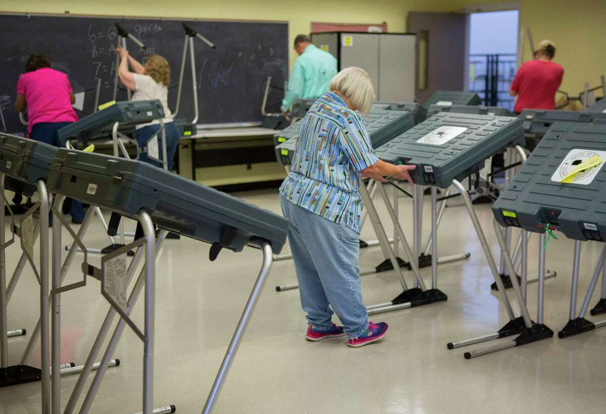 Volunteers set up voting machines for early voting at the West Gray Metropolitan Multi-Service Center, Monday, Feb. 19, 2018, in Houston. ( Mark Mulligan / Houston Chronicle )