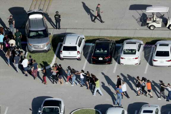 Students are evacuated by police from Marjory Stoneman Douglas High School in Parkland, Fla., after a shooter opened fire on the campus. (Mike Stocker/South Florida Sun-Sentinel)