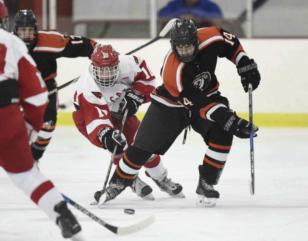 Greenwich's Sean Pratley (10) and Ridgefield's Will Forrest (14) battle for the puck in Greenwich's 5-3 win over Ridgefield in the high school boys hockey game at Dorothy Hamill Skating Rink in Greenwich, Conn. Monday, Feb. 19, 2018.