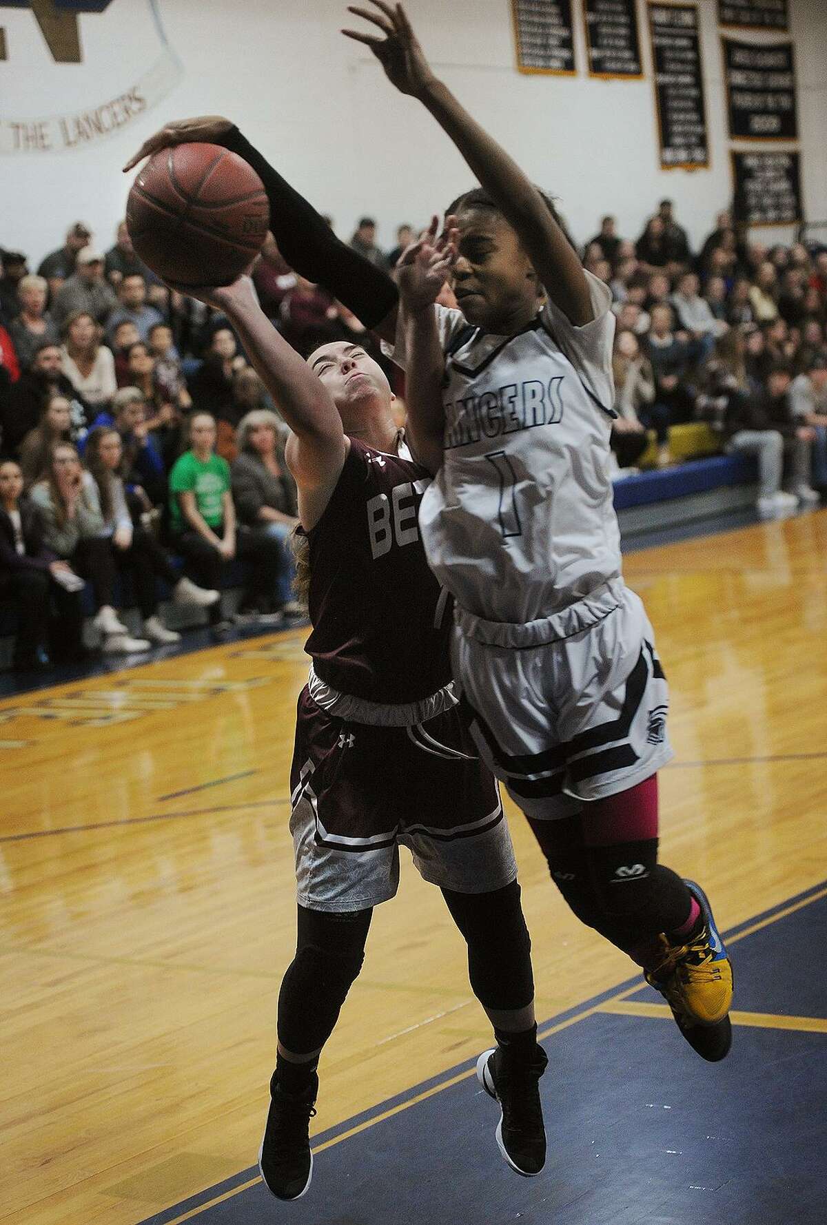 Bethel’s Mia Prazeres is fouled by Notre Dame of Fairfield’s Yamani McCollough in the first half of their SWC semifinal game at Notre Dame High School in Fairfield on Monday. ND-Fairfield won 46-40.
