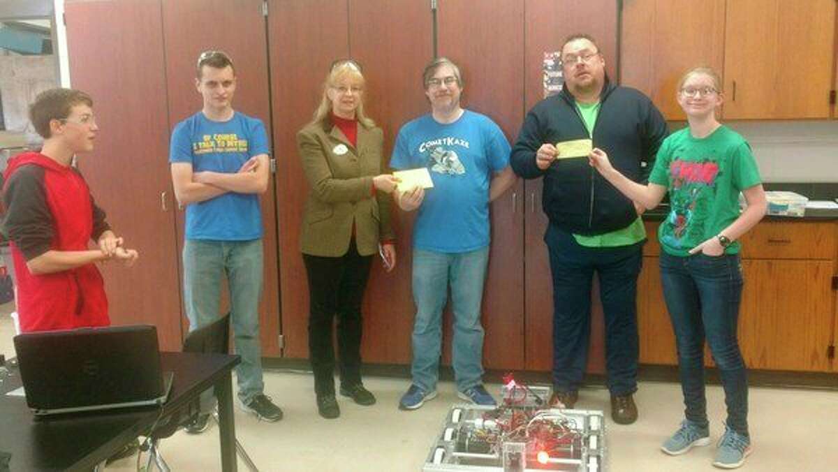 From left, Nicholas Rudy; William Houghten; Ann Sigsby, worthy matron of Coleman OES; Peter Cauchy, CometKaze coach; Fred Servis, past master of Warren Lodge; and Haley Nichols receive donations for their robotics competition. (Photo provided)