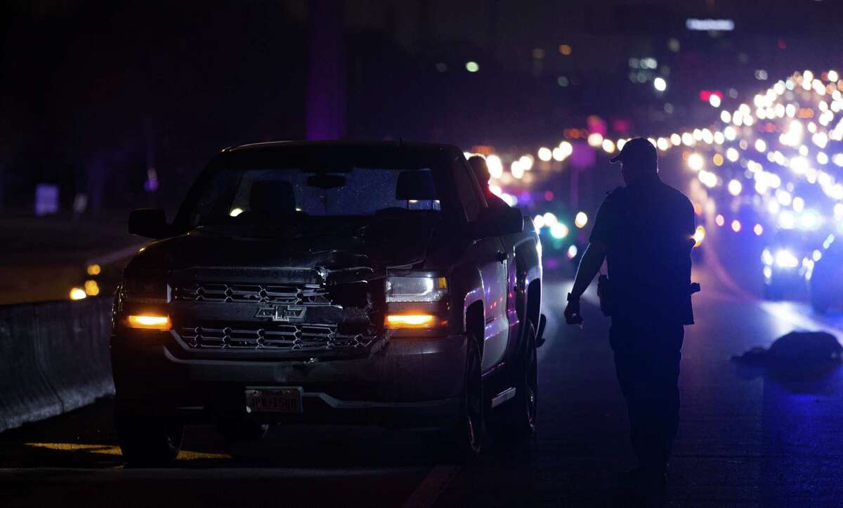 Houston Police officers investigate the scene where a woman was fatally struck by a vehicle on the southbound lanes of Gulf Freeway near Telephone Road Tuesday, Feb. 20, 2018.