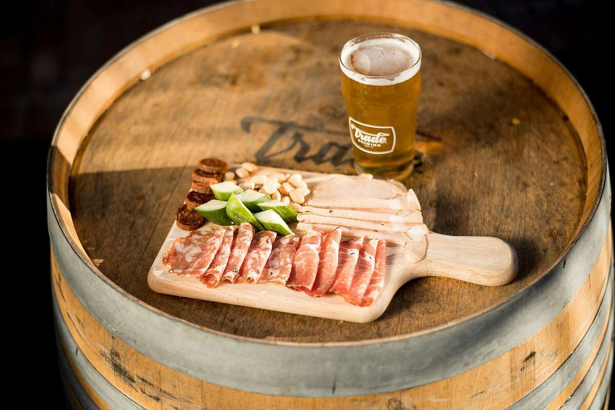 A charcuterie board rests on a barrel at Trade Brewing in Napa, Calif., on Saturday, Feb. 17, 2018.