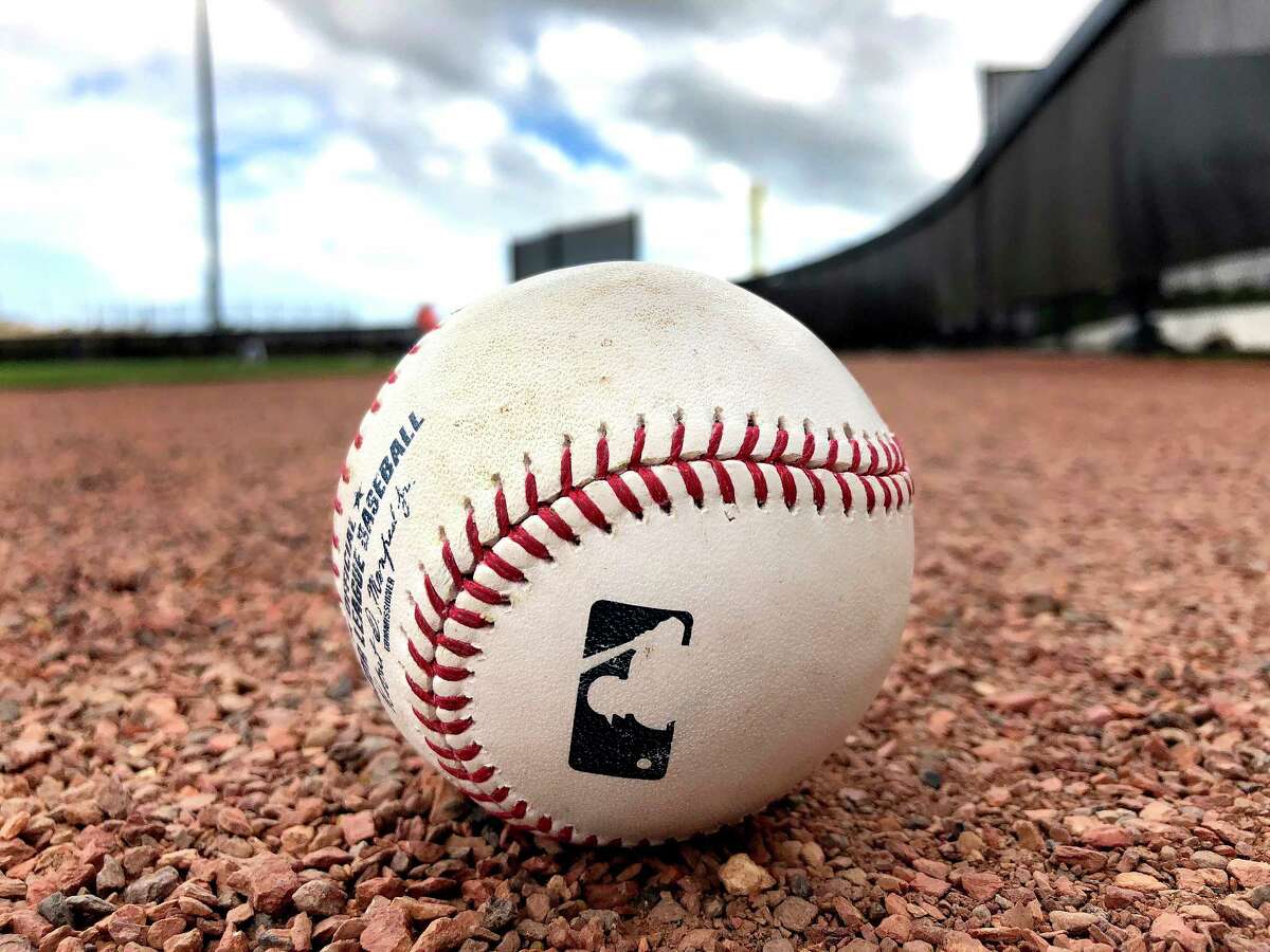 A baseball sits on the warning track of a field during spring training at The Ballpark of the Palm Beaches, Tuesday, Feb. 20, 2018, in West Palm Beach.