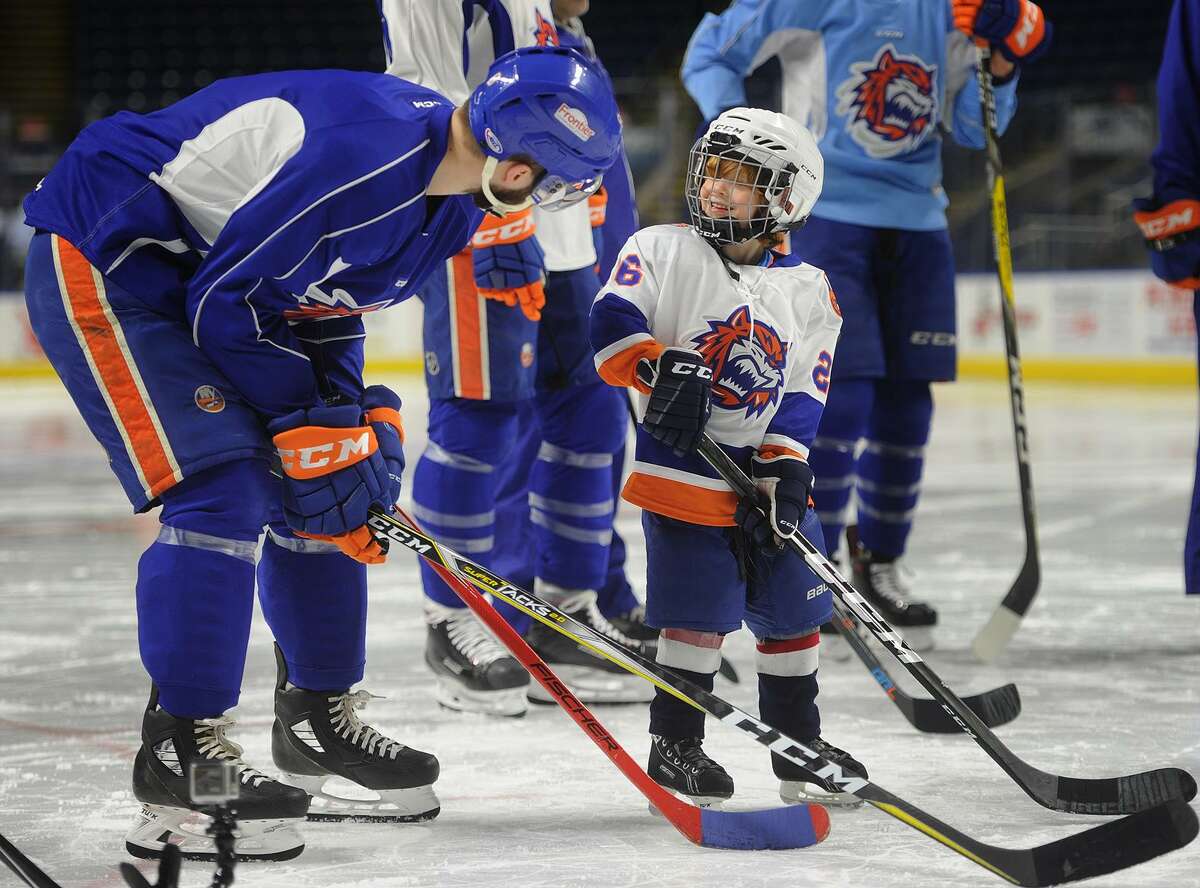 Bridgeport Sound Tiger Kyle Burroughs talks to Caleb Desjarlais, 4, one of two boys who joined the team as a player for the day through Make-A-Wish Connecticut at the Webster Bank Arena in Bridgeport, Conn. on Tuesday, February 20, 2018.