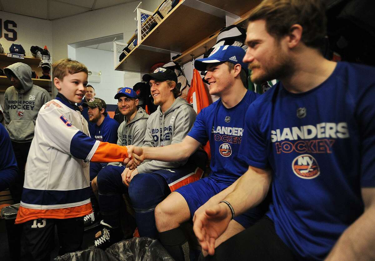 Sam Lopa, 11, left, is greeted by Bridgeport Sound Tiger players as he joined the team for the day through Make-A-Wish Connecticut at the Webster Bank Arena in Bridgeport, Conn. on Tuesday, February 20, 2018.