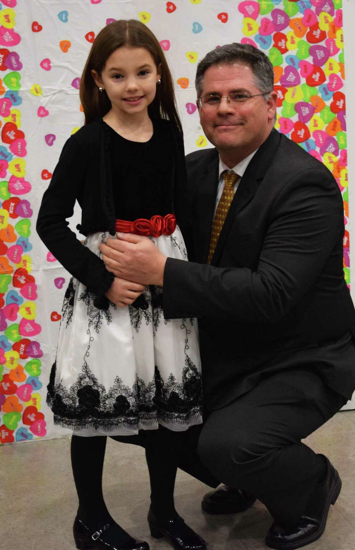 Spectrum/Fred Peloso and his daughter, Samantha, 10, pause to have their photo taken at the start of the New Milford Girl Scouts annual Sweetheart Dance, sponsored this year by Troop 40236, at New Milford High School Feb. 9, 2018.
