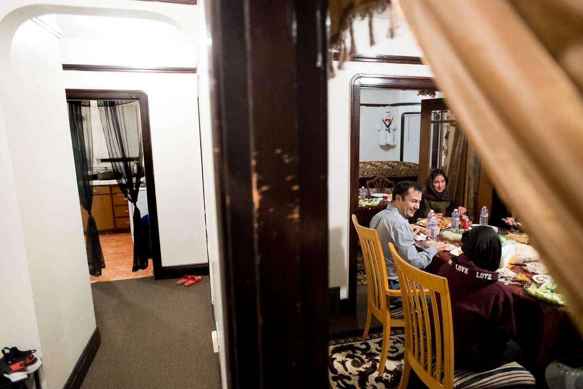 Abdul Nassimi eats dinner with his family in their Oakland, Calif., home on Sunday, Feb. 11, 2018. At right is daughter Manizgha, 17.