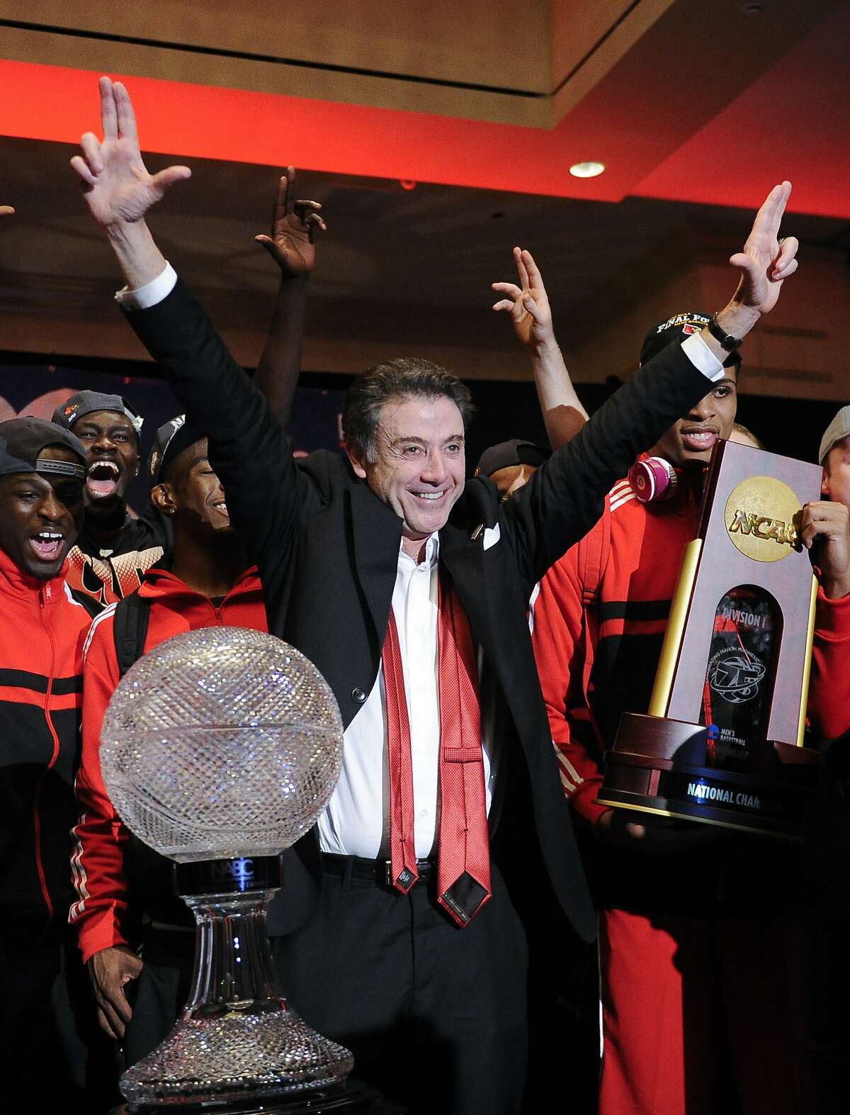 FILE - In this April 8, 2013, file photo, Louisville coach Rick Pitino celebrates at the the trophy ceremony after winning the NCAA Final Four tournament college basketball championship game against Michigan, in Atlanta. Louisville must vacate its 2013 men�s basketball title following an NCAA appeals panel�s decision to uphold sanctions against the men�s program for violations committed in a sex scandal. The Cardinals will have to vacate 123 victories including the championship, and return millions in postseason revenue. The decision announced on Tuesday, Feb. 20, 2018, by the governing body�s Infraction Appeals Committee ruled that the NCAA has the authority to take away championships for what it considers major rule violations. (AP Photo/John Amis, File)