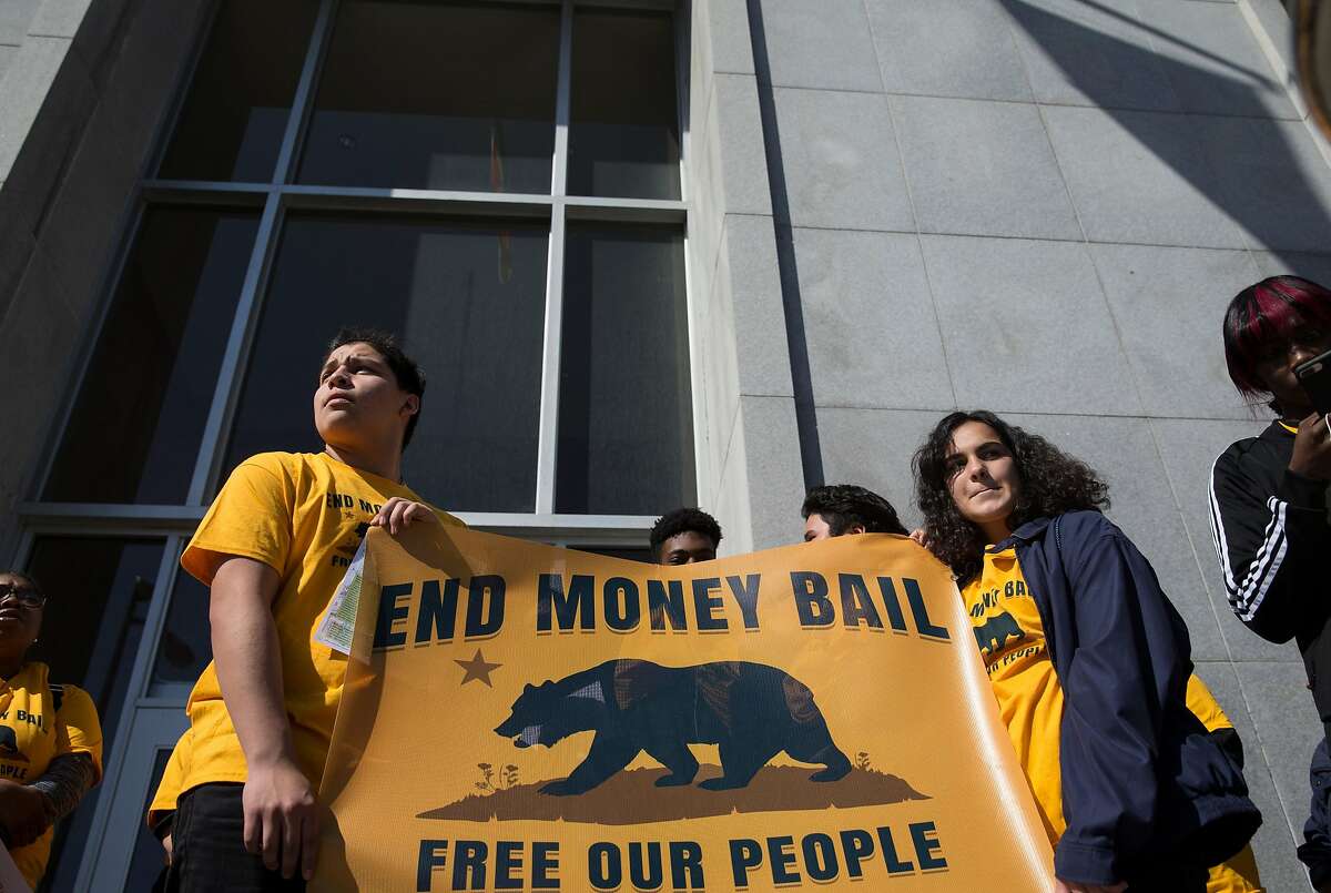 Supporters and activists gather on the steps of the Hall of Justice during a rally calling for the end of the money bail system in California Tuesday, Feb. 20, 2018 in San Francisco, Calif.