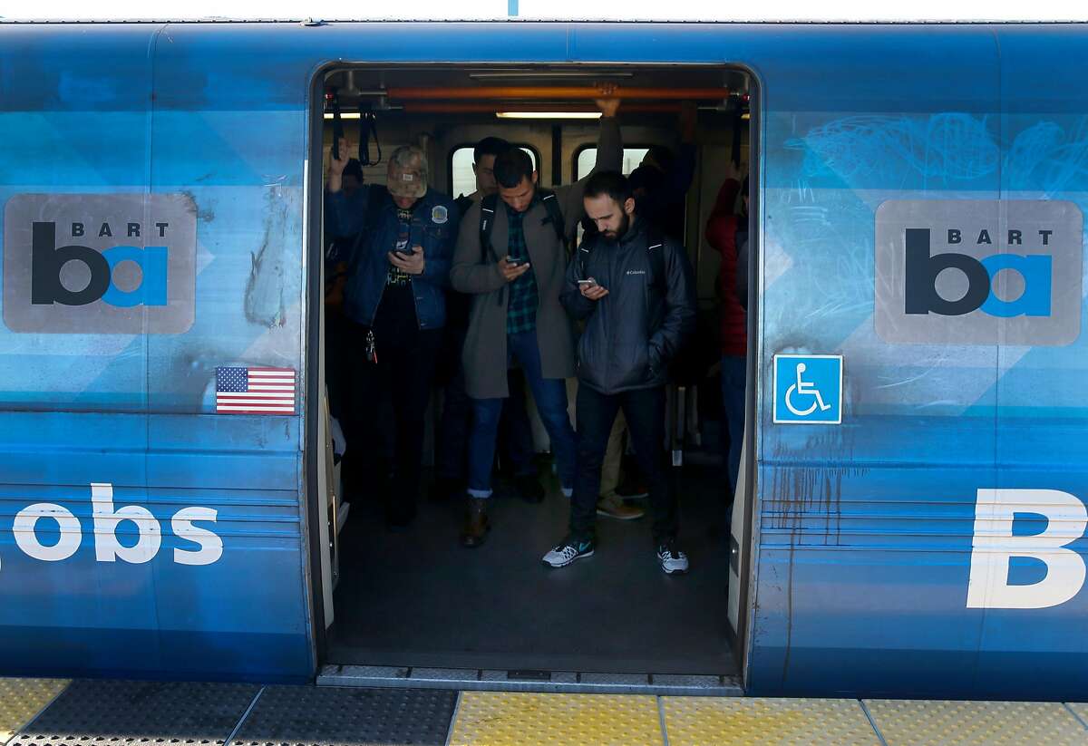 Passengers wait for a westbound train to depart the West Oakland BART station in Oakland, Calif. on Friday, Feb. 16, 2018. BART officials will begin a study on the feasibility of a second transbay tube.