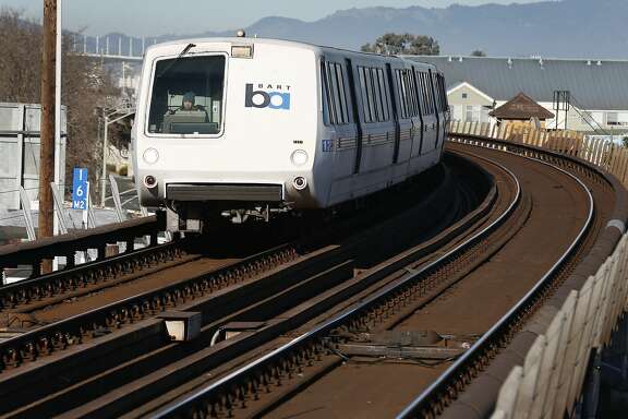 a bart train arrives at the west oakland station after