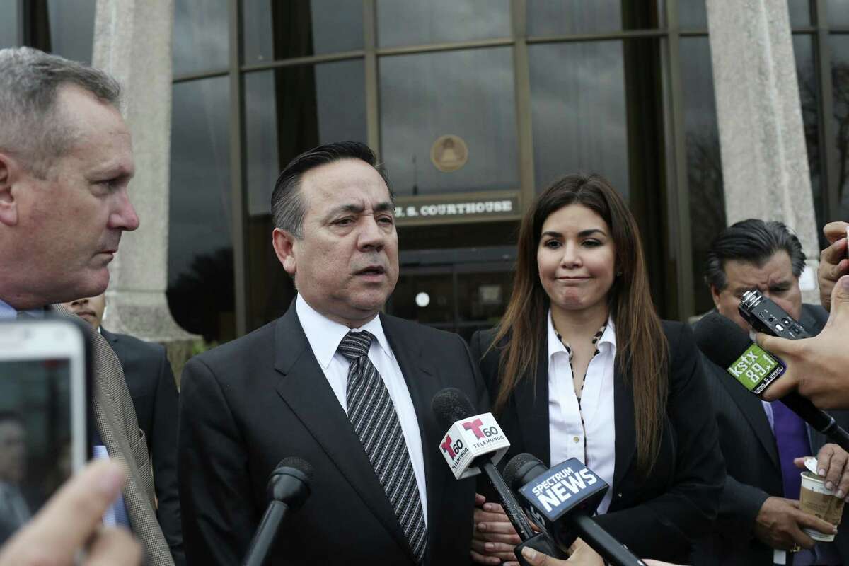 Standing with his wife, Lleanna Uresti, and his attorney Michael McCrum, Texas State Sen. Carlos Uresti talks with the media as they leave the John H. Wood, Jr., United States Courthouse for the day, Tuesday, Feb. 20, 2018. A week after his conviction, his wife has filed for divorce.