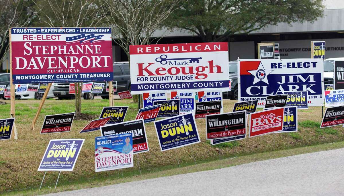 Political signs line the street to the East Montgomery County Courthouse on the first day of Early Voting, Tuesday, Feb. 20, 2018, in New Caney.