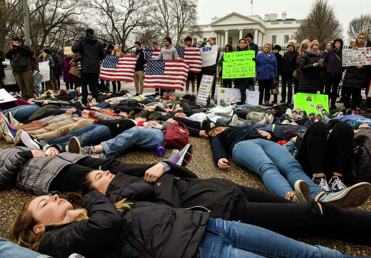 Students stage a "lie-in" Monday, Feb. 19, 2018,  outside the White House in response to the school shooting Wednesday in Florida. The teens said they want stronger gun control and vowed to be heard on the issue. MUST CREDIT: Washington Post photo by Bill O'Leary