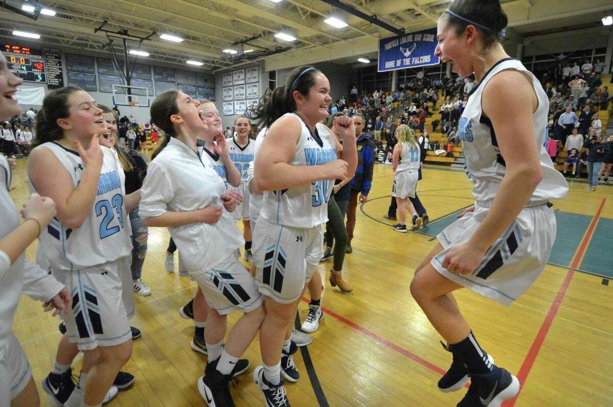 The Wilton team celebrates the victory over Fairfield Warde in Tuesday’s semifinal game in Fairfield.
