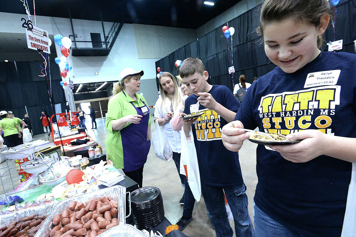 West Hardin's Cailyn Trousdale enjoys a sample at the 18th annual Region 5 Food Service Cooperative's food show and tasting at the Civic Center Tuesday. Food service workers, teachers, administrators and students from the region's 50 districts, charter schools, churches and childcare centers got a chance to sample some of the latest menu items geared toward school cafeterias. With a shared goal of taste and nutrition in mind, vendors offered up a variety of food and beverages. Samplers then could vote on which of the items they liked best. The event offers districts the chance to improve upon their menus. Photo taken Tuesday, February 20, 2018 Kim Brent/The Enterprise
