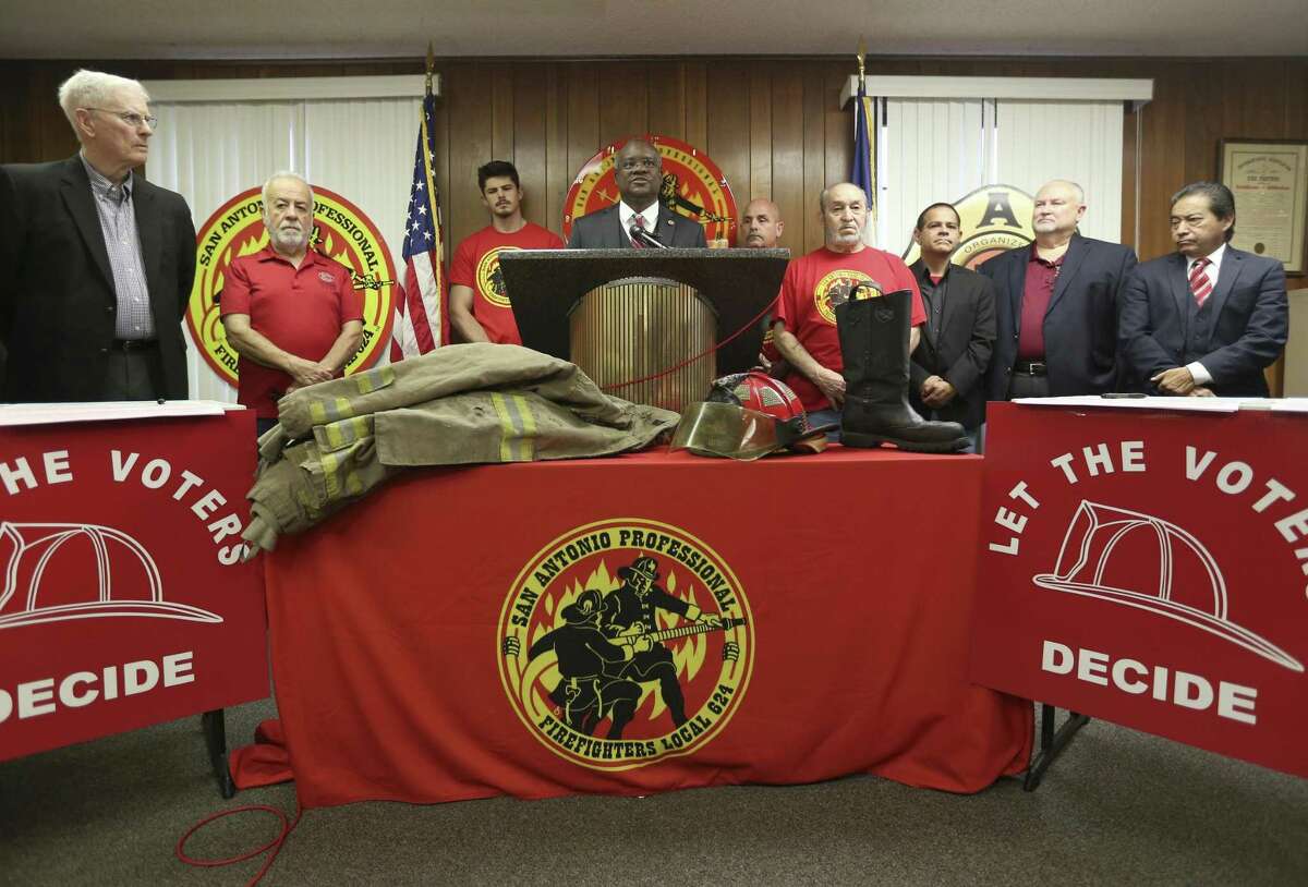 Chris Steele, San Antonio Professional Fire Fighters union president, at lectern, announces Tuesday, Feb. 20, 2018, during a union hall news conference the union is starting a petition drive calling for three city charter amendments for the November ballot.
