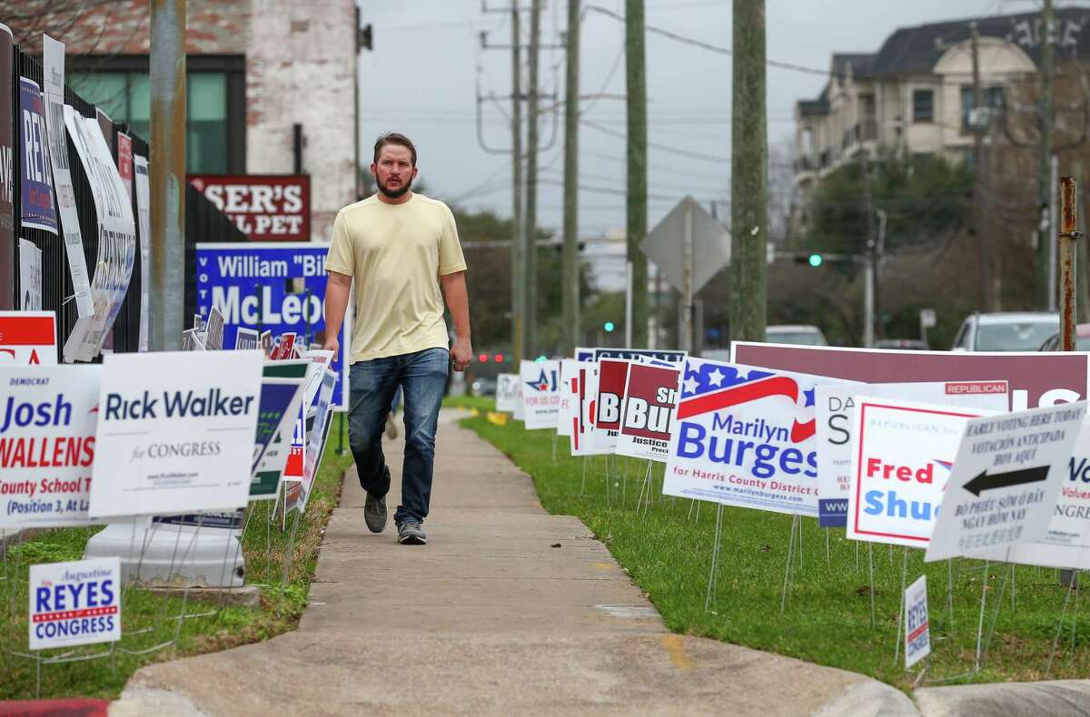 Campaign signs surround a sidewalk on West Gray Street outside the early voting station at the Metropolitan Multi-Services Center. Democrats showed a 300 percent gain and Republicans a 25 percent jump in Tuesday's totals compared to 2014.