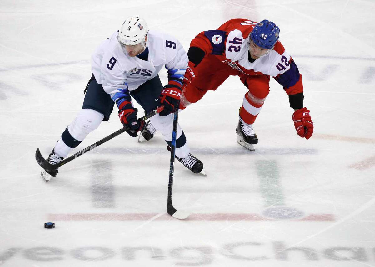 Brian O'Neill (9), of the United States, and Petr Koukal (42), of the Czech Republic, battle for the puck during the third period of the quarterfinal round of the men's hockey game at the 2018 Winter Olympics in Gangneung, South Korea, Wednesday, Feb. 21, 2018.