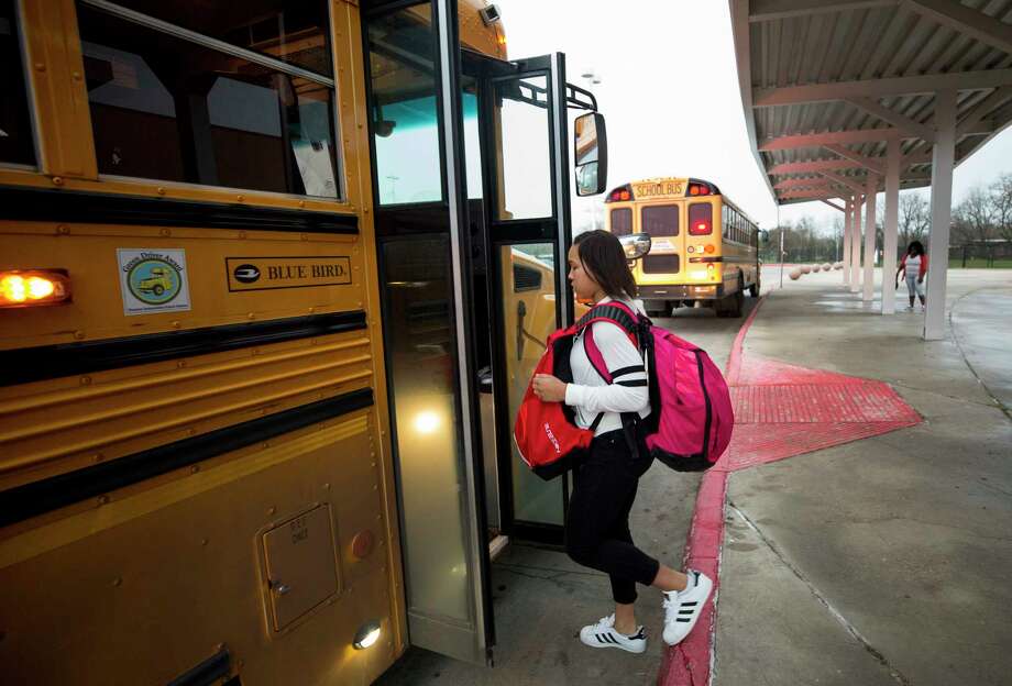 Fifteen-year-old Nia McGee boards the HISD bus that takes her to Bellaire High School Thursday, Feb. 15, 2018, in Houston. Nia, who lives in Sunnyside, takes the 10-mile bus ride to a school with more resources. Photo: Godofredo A. Vasquez / Godofredo A. Vasquez