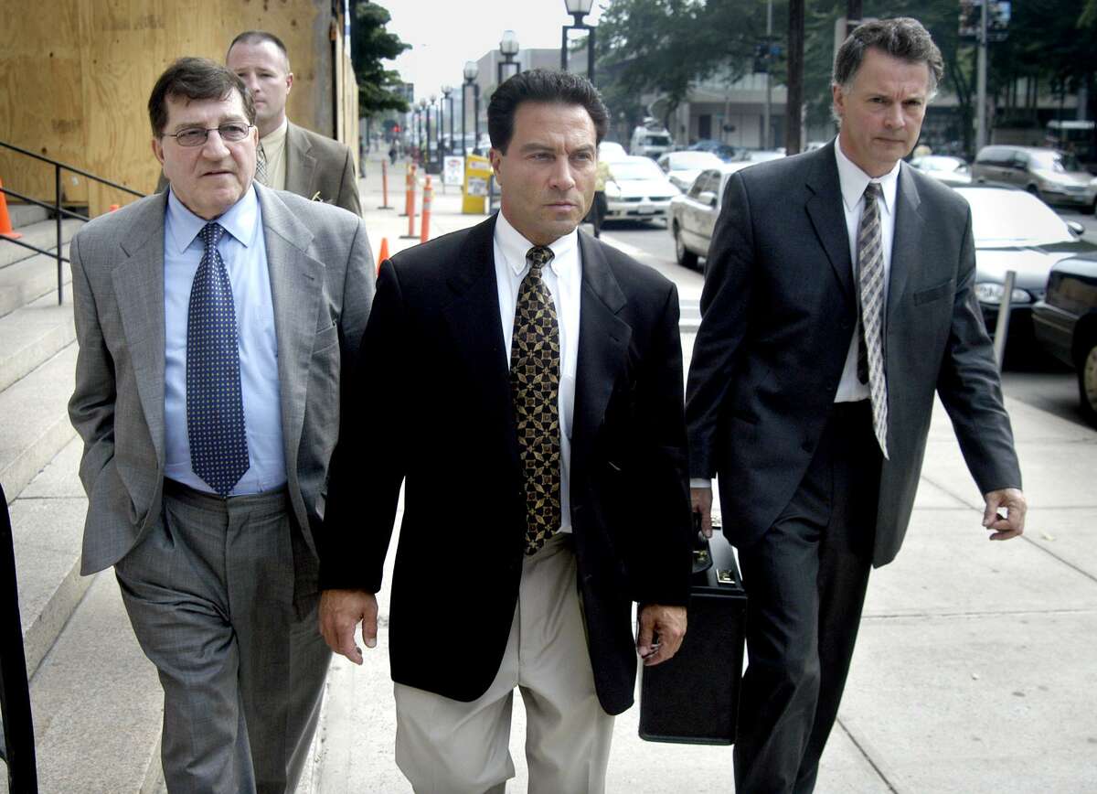 Alfred Lenoci Jr. (right) leaves the Federal Courthouse in New Haven, Conn. after being sentenced to 18 months in prison On the left is Alfred Lenoci Sr.
