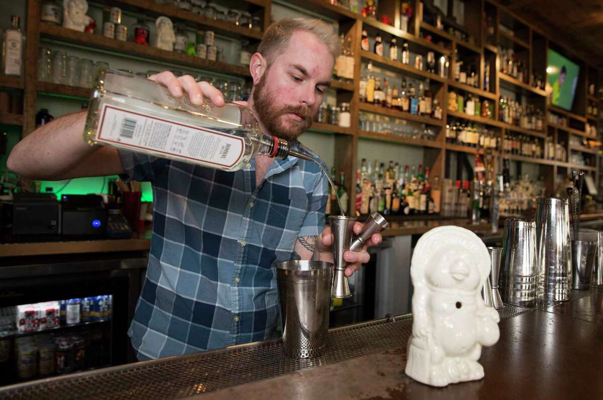Izakaya Bar Manager Alex Coon making a Saturn cocktail to pour into a Buddha bear mug on Thursday, Feb. 8, 2018, in Houston. ( Yi-Chin Lee / Houston Chronicle )