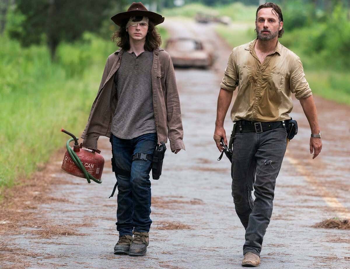 Andrew Lincoln (right) as Rick Grimes, Chandler Riggs as Carl Grimes in “The Walking Dead.” Midseason return: 8 p.m. Sunday, AMC.