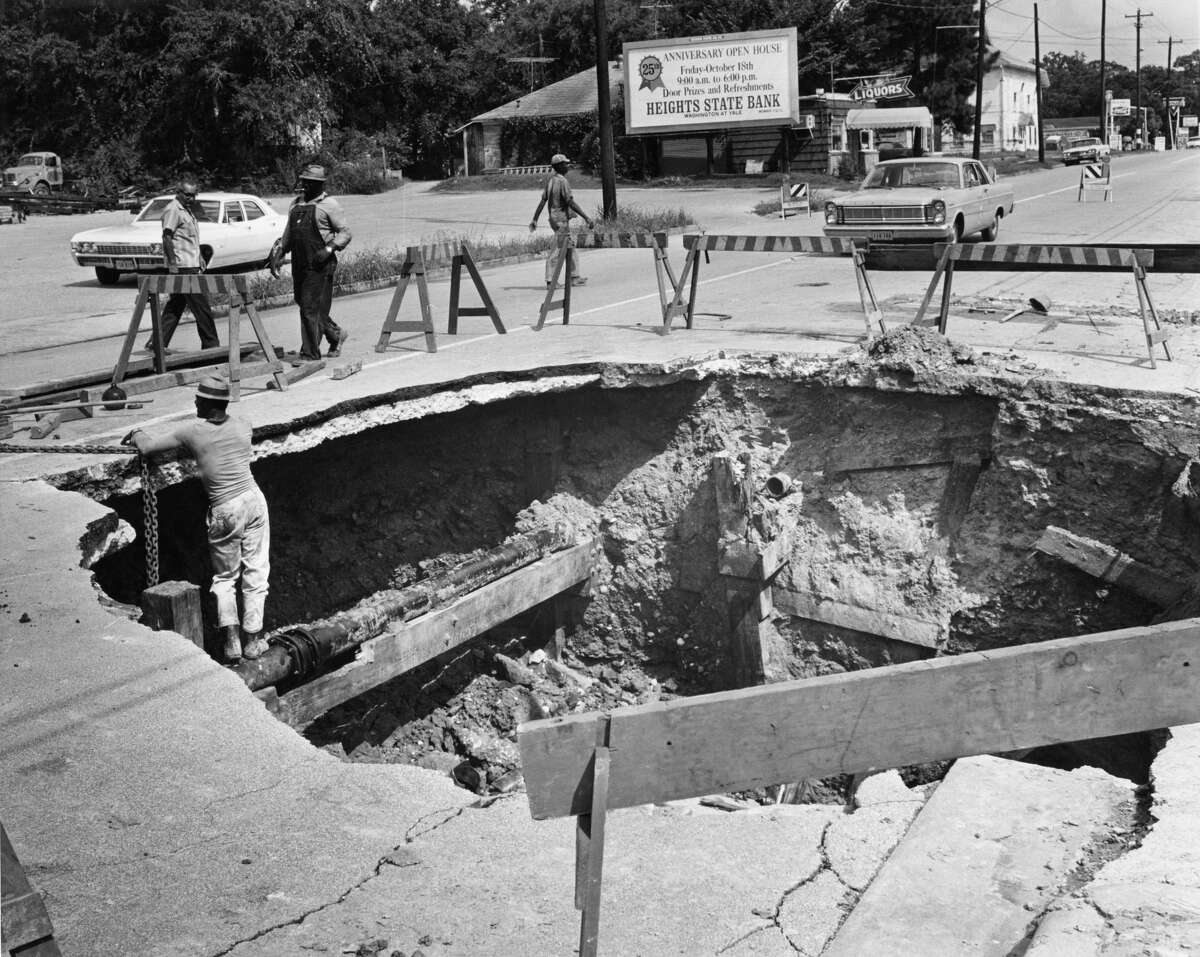 Back in October 1968 a big hole opened up in the 2800 block of White Oak in Houston when a leaking storm sewer caused a gas main to break. Initially, workmen dug a small hole to fix the gas main; but as the sewer leak continued overnight, the road collapsed in the middle of the night and the large hole was created. The collapse caused a second water main to break so White Oak was closed to traffic between Studemont and Oxford. See how sinkholes have impacted areas across the world...