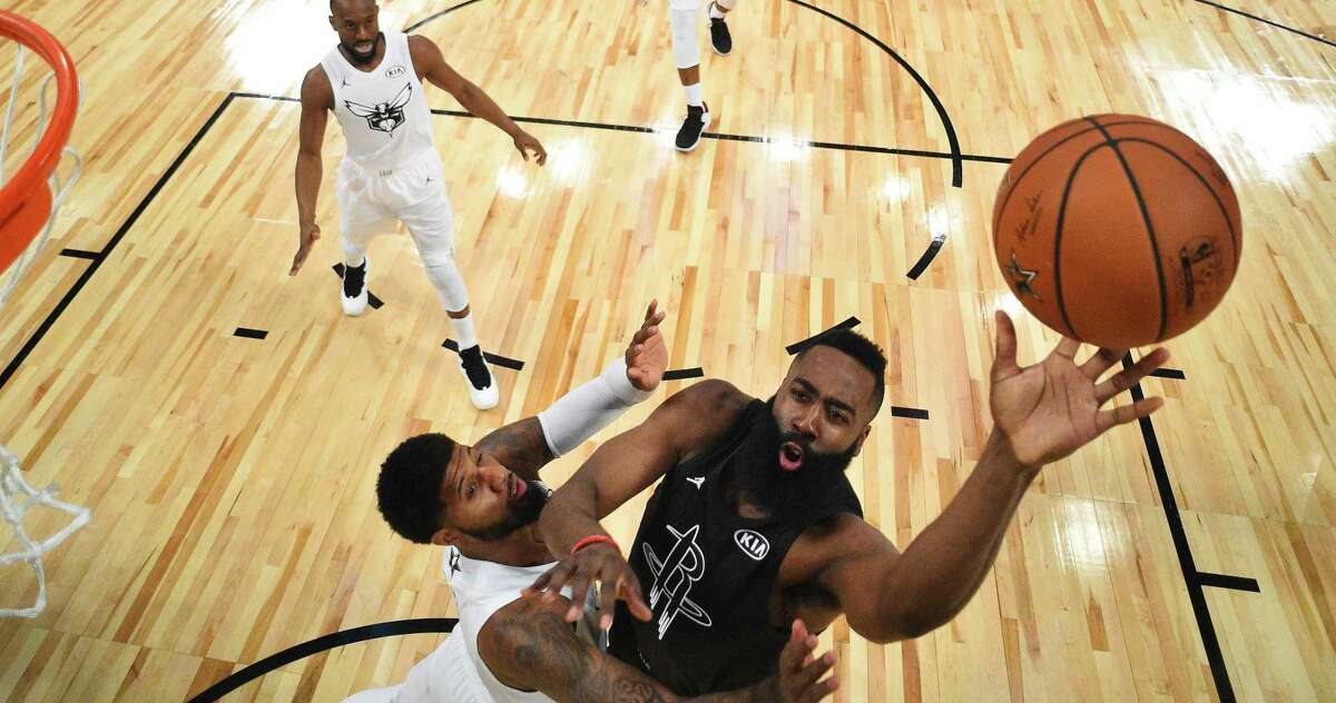 Team Stephen's James Harden, right, of the Houston Rockets, shoots as Team LeBron's Paul George, of the Oklahoma City Thunder, defends during the second half of an NBA All-Star basketball game, Sunday, Feb. 18, 2018, in Los Angeles. (Bob Donnan via AP, Pool)