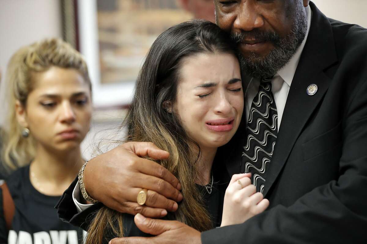 Aria Siccone, 14, a 9th grade student survivor from Marjory Stoneman Douglas High School, where more than a dozen students and faculty were killed in a mass shooting on Wednesday, cries as she recounts her story from that day, while state Rep. Barrinton Russell, D-Dist. 95, comforts her, as they talk to legislators at the state Capitol regarding gun control legislation.