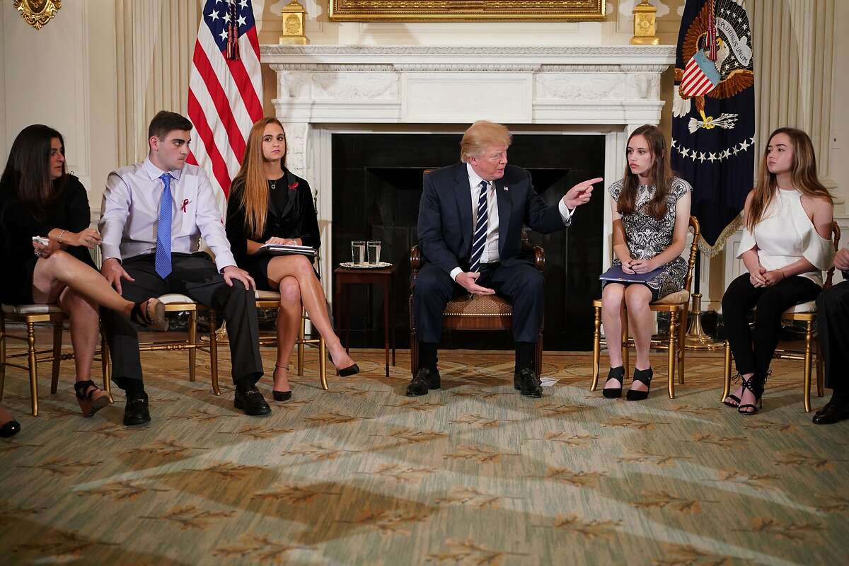 President Donald Trump takes part in a listening session on gun violence with teachers and students in the State Dining Room of the White House on February 21, 2018. Trump promised more stringent background checks on gun owners Wednesday as he hosted a group of students who survived last week's mass shooting at a Florida high school. 