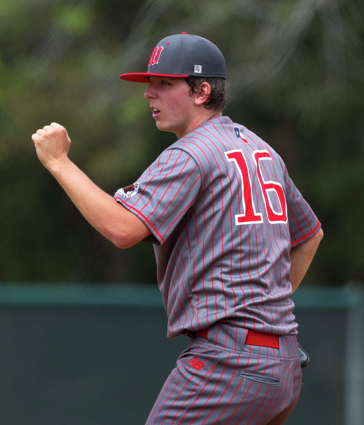 The Woodlands starting pitcher Steven Beard (16) gives a fist pump after a strike call during the fifth inning of a high school baseball game at the Wings-N-More Classic Friday, March 10, 2017, in The Woodlands. The Woodlands defeated Keller 16-4.