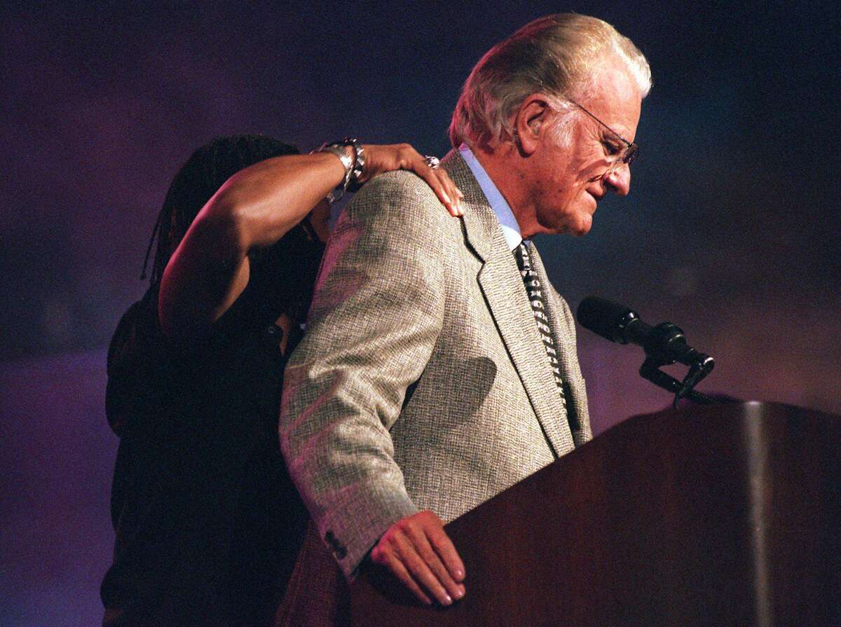 dc Talk band member Michael Tait jokes around with Dr. Billy Graham during day 3 of the crusade at the Alamodome in 1997. PHOTO BY JERRY LARA