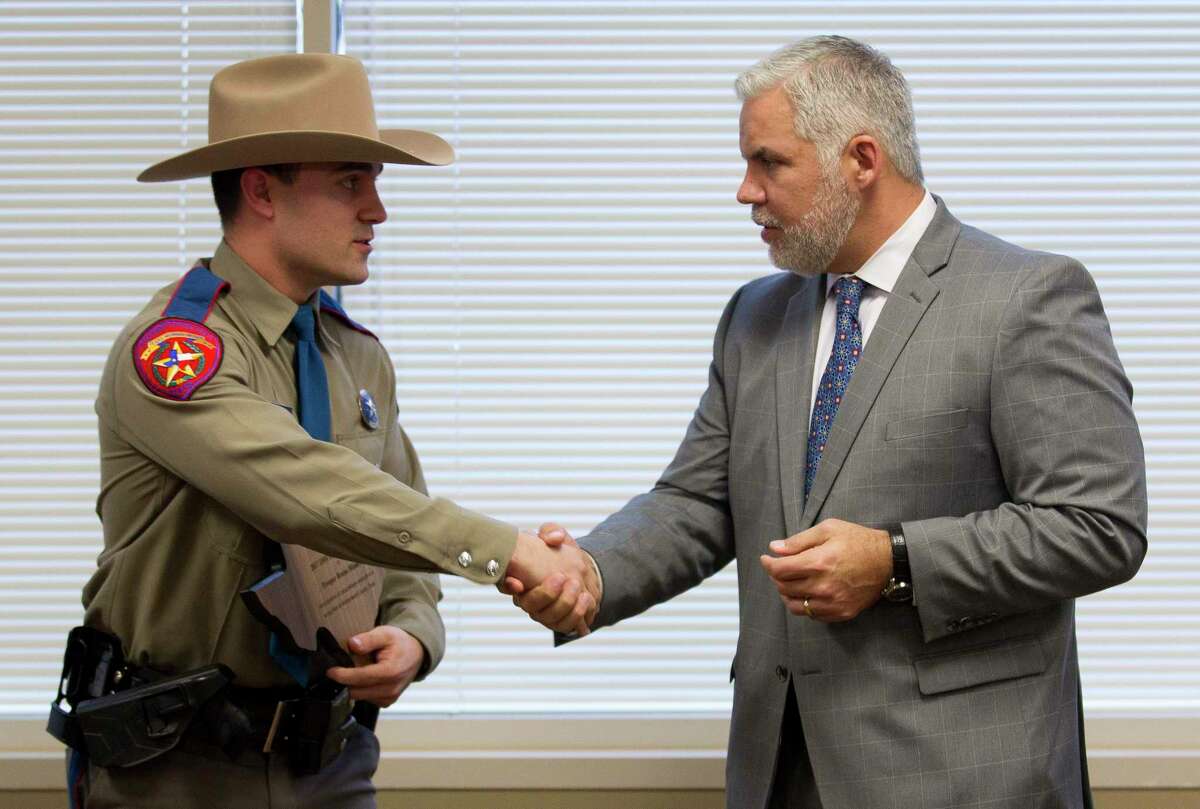 State Trooper Bruno Miauro, left, shakes hands with Montgomery County District Attorney Brett Ligon after being named the DWI Officer of the Year during the Montgomery County District Attorney's annual DWI awards at the Lee G. Alworth Building, Wednesday, Feb. 21, 2018, in Conroe.