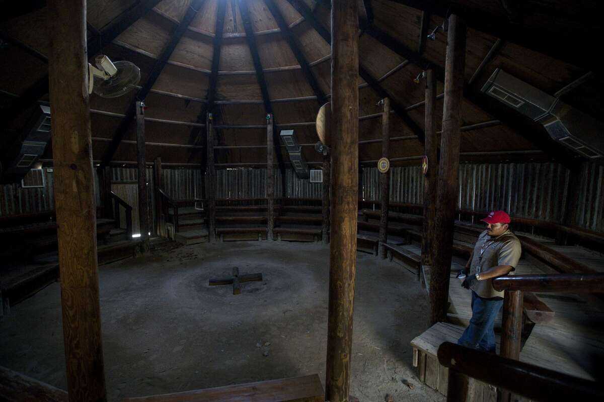 Jordan Williams, a member of the Alabama-Coushatta Tribe and works at Naskila Gaming, looks over the former tourist attraction, Tribal Council House, a former tourist attraction, near Livingston. Williams, who lives on the reservation and works at the gaming center, explained how the tribe previously drew income from tourist attractions showcasing their history. A fire reportedly destroyed much of the tourist areas, which eliminated a primary source of income for the members.