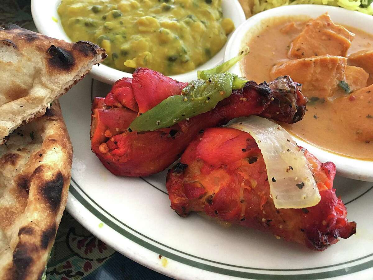 Tandoori chicken flanked by naan, chana daal and chicken tikka masala from Simi's India Cuisine.