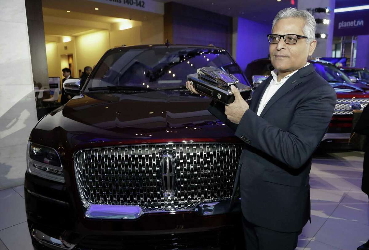 FILE- In this Jan. 15, 2018, file photo, Kumar Galhotra, group vice president for Lincoln stands next to the 2018 Lincoln Navigator after the vehicle won truck of the year during the North American International Auto Show in Detroit. Ford Motor Co. said Thursday, Feb. 22, that it is naming Galhotra as a replacement for Raj Nair, the president for North America who was ousted this week over allegations of inappropriate behavior. Galhotra will take over on March 1.