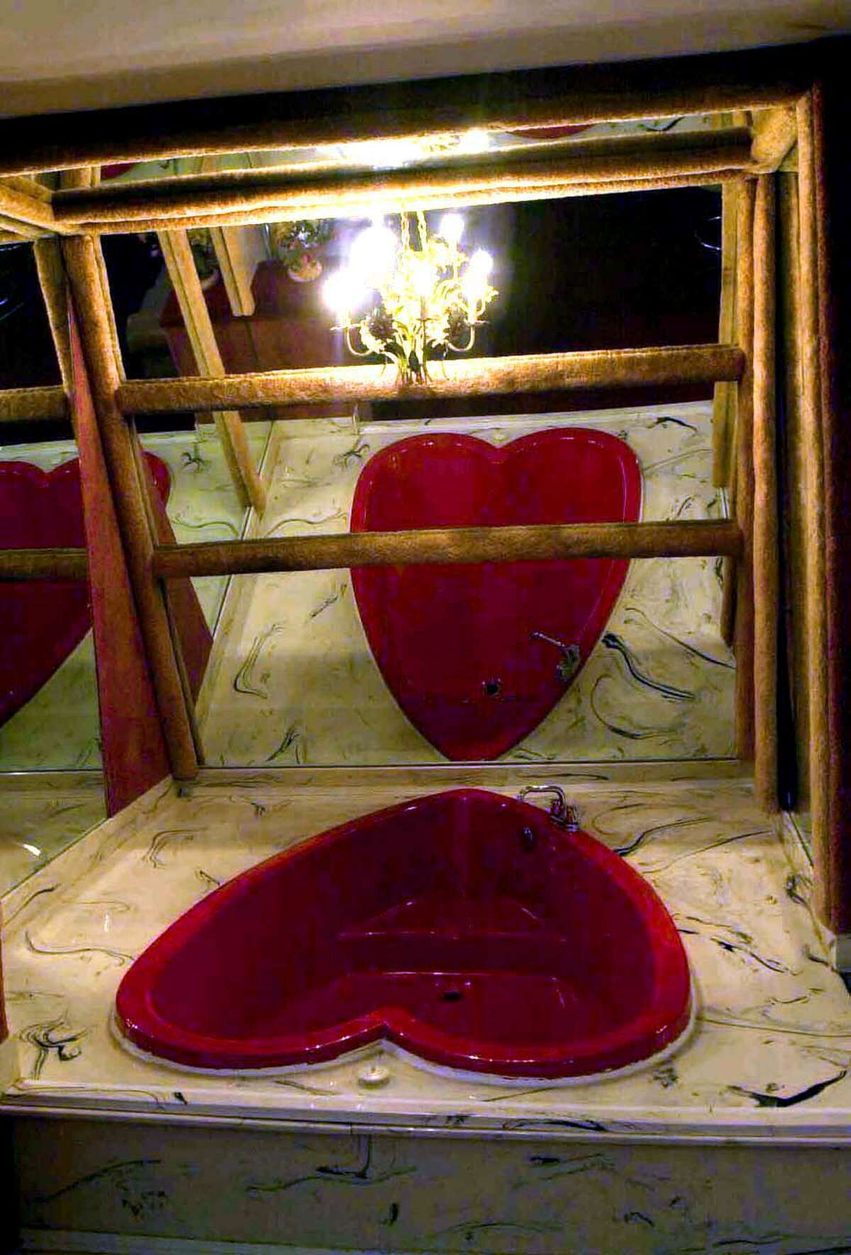A heart shaped Jacuzzi is surrounded by mirrors and lights in one of the Valentine Rooms at the Governors Inn on Wednesday, Feb. 5, 2003, in Guilderland, N.Y. (Steve Jacobs/Times Union)