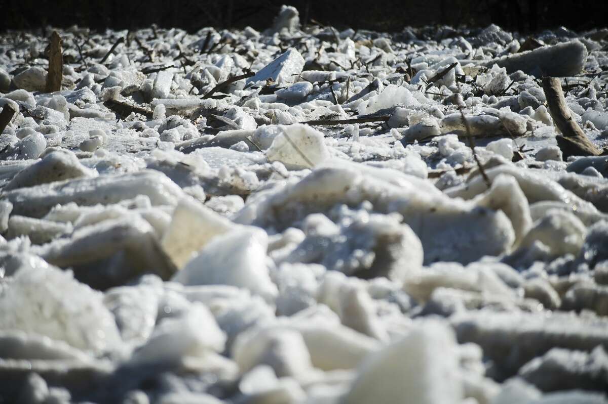 Large sheets and chunks of ice are piled up in the Chippewa River in the backyard of Midland resident Gene Anderson on Thursday, Feb. 22, 2018. Flooding caused the ice to slowly inch further onto Anderson's property, though it never reached his home. (Katy Kildee/kkildee@mdn.net)