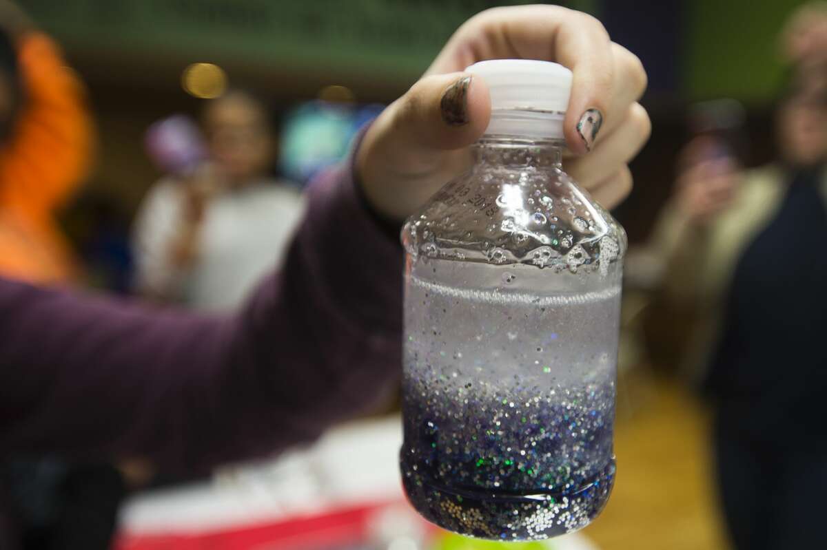 Children create galaxy-themed glitter shakers during The ROCK after school program on Thursday, Feb. 22, 2018 at the Greater Midland Community Center. (Katy Kildee/kkildee@mdn.net)