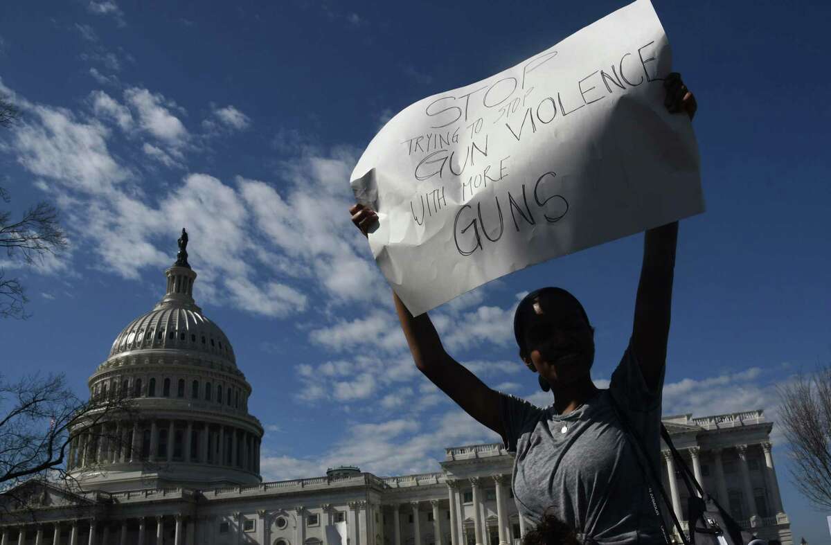 A student hoists a sign as hundreds of high school and middle school students from the District of Columbia, Maryland and Virginia staged walkouts and gathered Wednesday in front of the Capitol in support of gun control in the wake of the Florida shooting. / AFP PHOTO / Olivier DoulieryOLIVIER DOULIERY/AFP/Getty Images